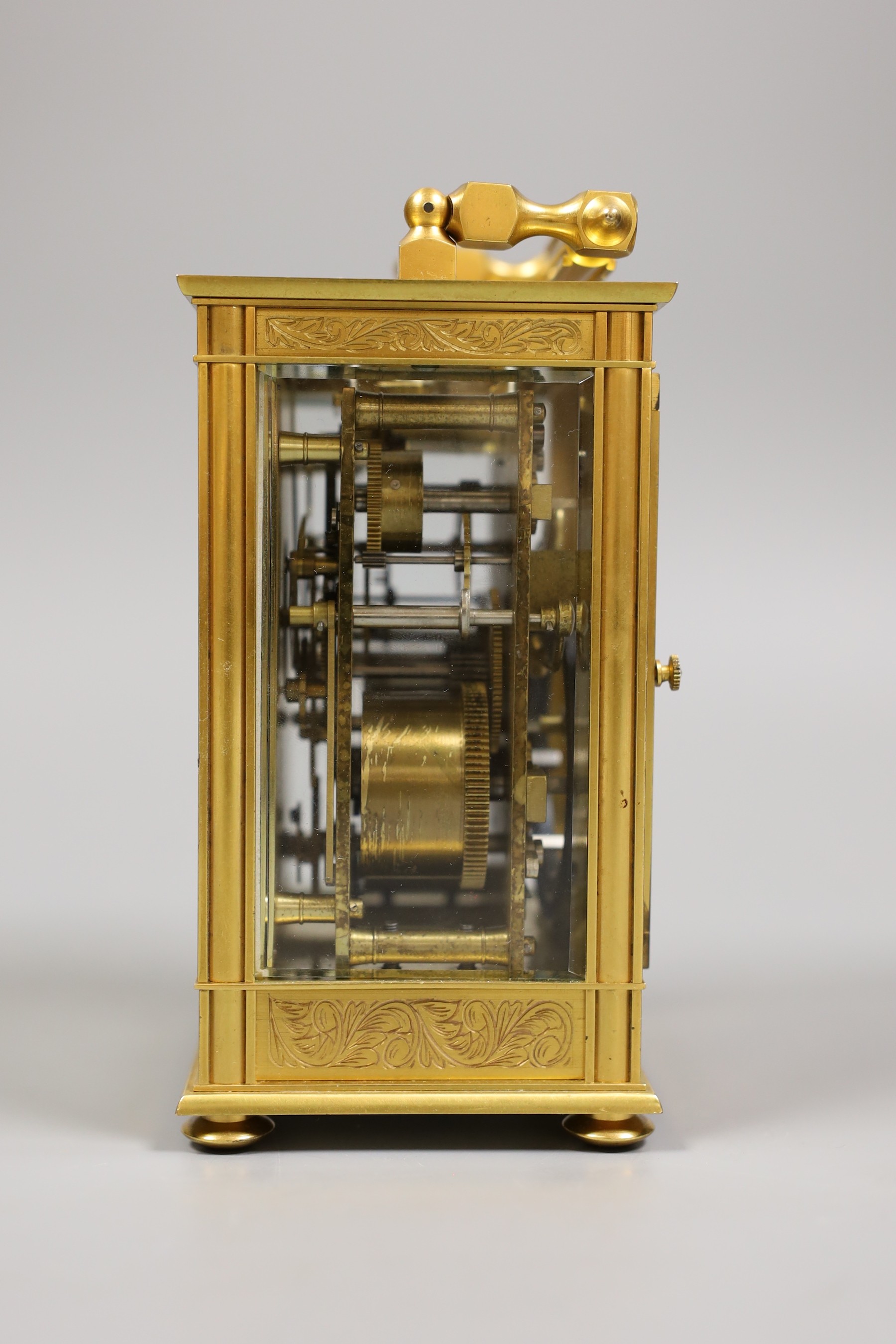 A French repeating carriage clock with alarm and with inlaid scroll decoration, with key, 19cm tall